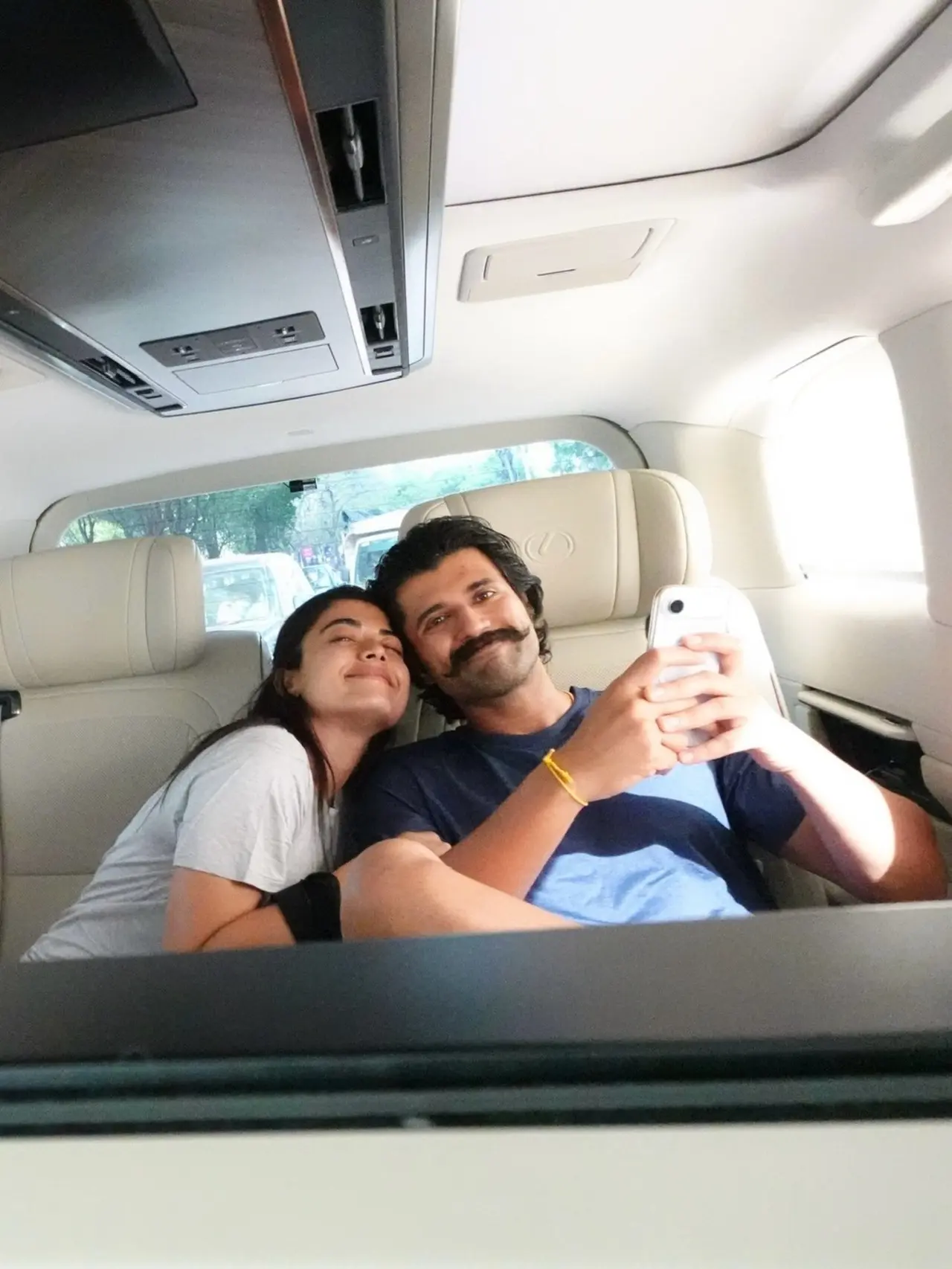 Rashmika and Vijay were seen posing while sitting in the car as they headed to a friend's house to celebrate his birthday. Rashmika and Vijay were seen posing while sitting in the car as they headed to a friend's house to celebrate his birthday.