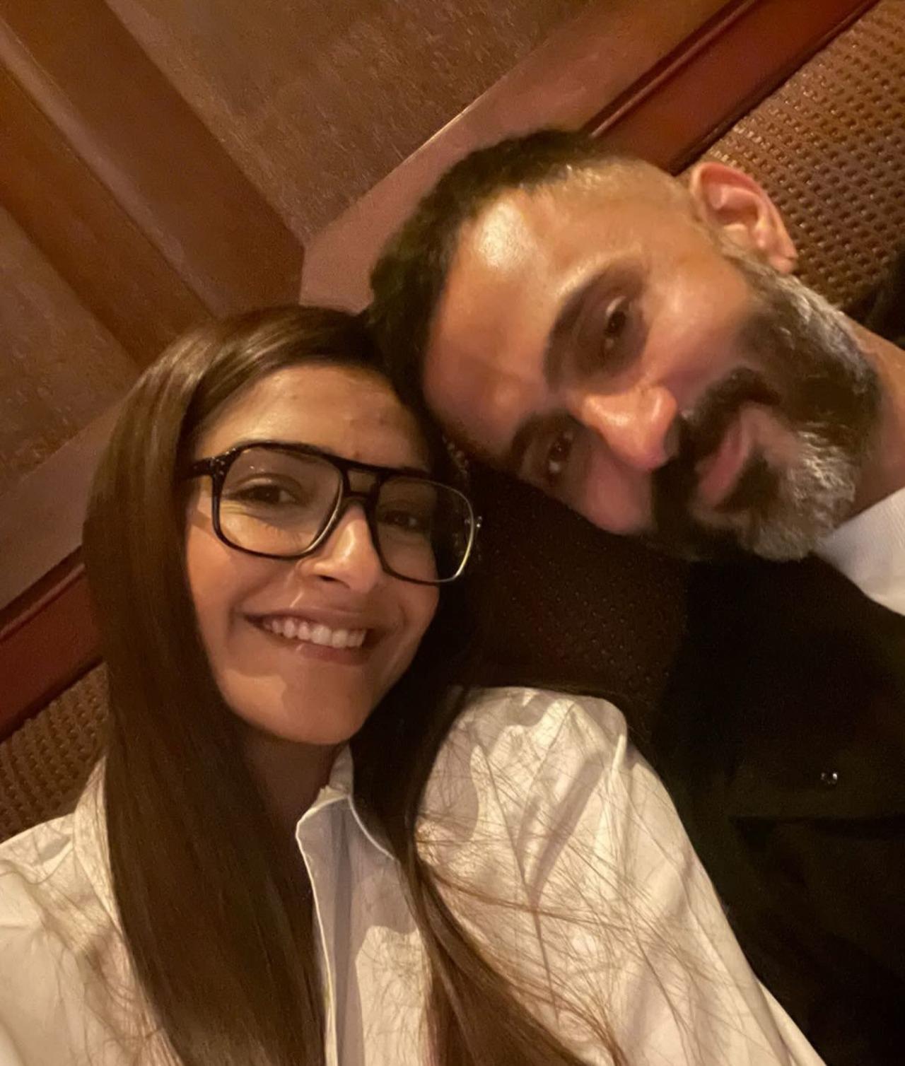 Sonam and Anand are seen posing for a cute selfie. Sonam is seen in a white outfit with round glasses, while Anand wears a black coat over a white t-shirt. Sonam and Anand are seen posing for a cute selfie. Sonam is seen in a white outfit with round glasses, while Anand wears a black coat over a white t-shirt.