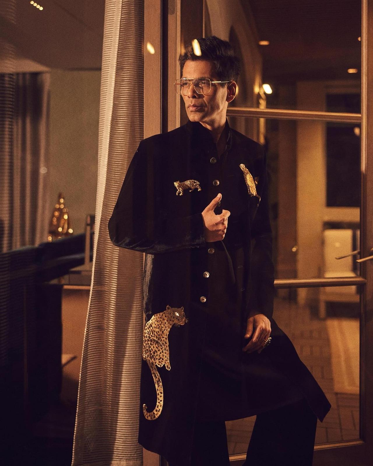 Karan rocked this customised black silk velvet sherwani featuring hand-embroidered gold sequin leopard and tiger motifs.