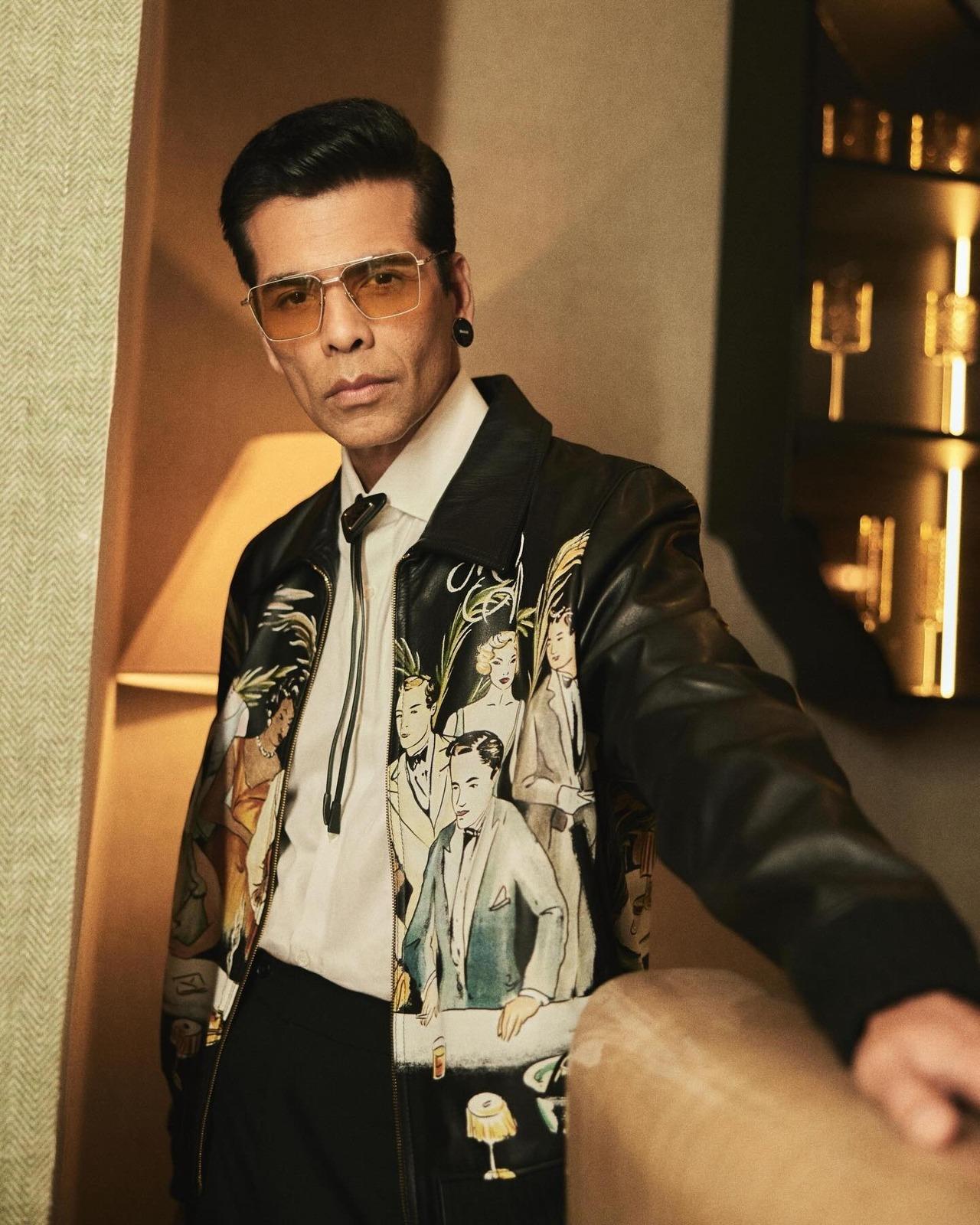 Bringing in some drama, Karan wore this fun graphic leather jacket, pairing it with a bolo tie and classy eyewear.