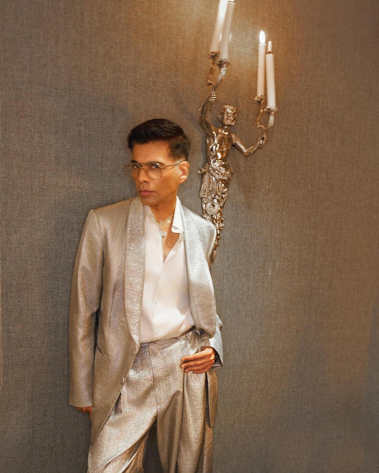 Karan shines in this metallic suit featuring a striking textured finish. He perfectly complements to outfit with designer eyewear and bespoke jewellery.