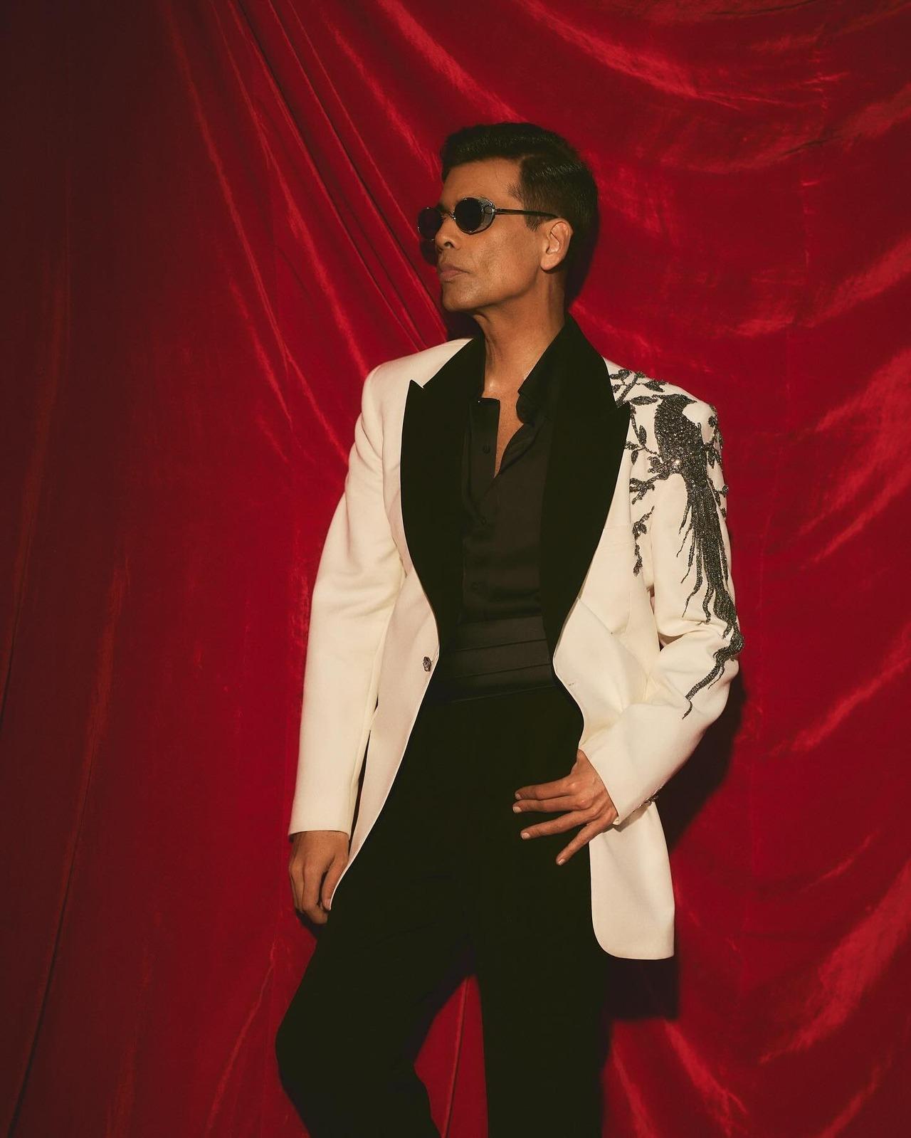 Karan makes heads turn in this custom white and black tuxedo, featuring intricate beaded embroidery on the shoulder, which adds a touch of drama and glam.