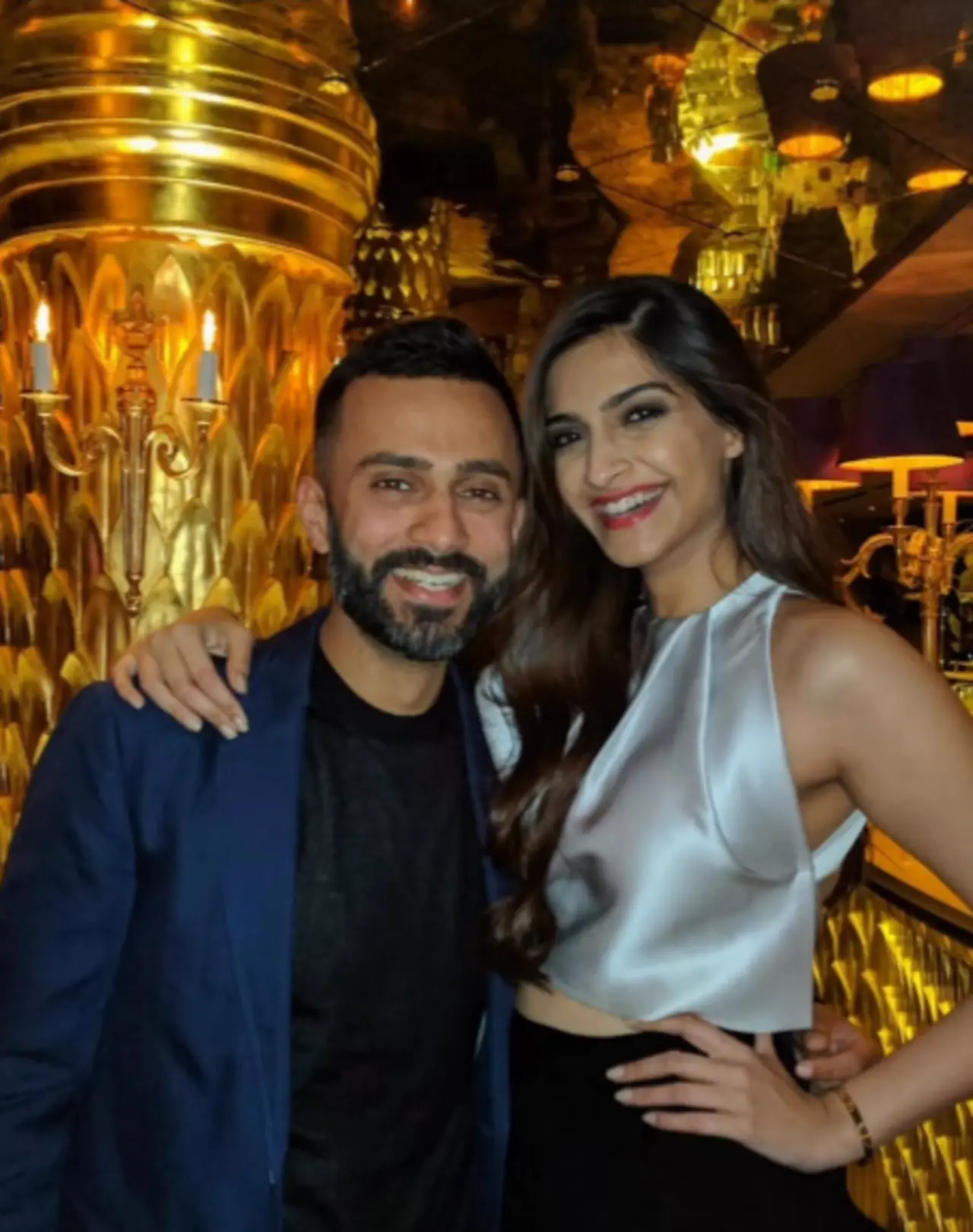 In this glamorous and happy picture, Sonam and Anand are seen posing adorably with the actress placing her hand on his shoulder, as they flash their brightest smiles. In this glamorous and happy picture, Sonam and Anand are seen posing adorably with the actress placing her hand on his shoulder, as they flash their brightest smiles.