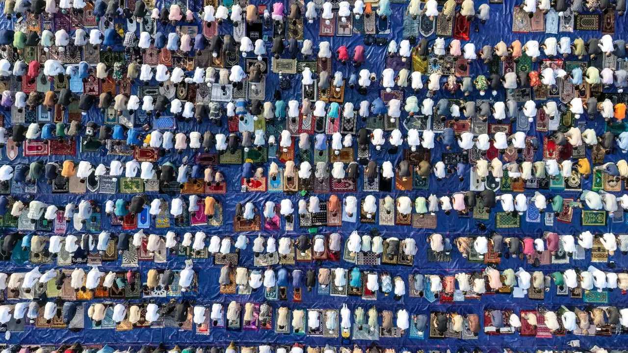 An aerial view captures Indonesian Muslims offering Eid al-Adha prayers at Ancol Beach in Jakarta, forming large congregational rows along the shoreline An aerial view captures Indonesian Muslims offering Eid al-Adha prayers at Ancol Beach in Jakarta, forming large congregational rows along the shoreline
