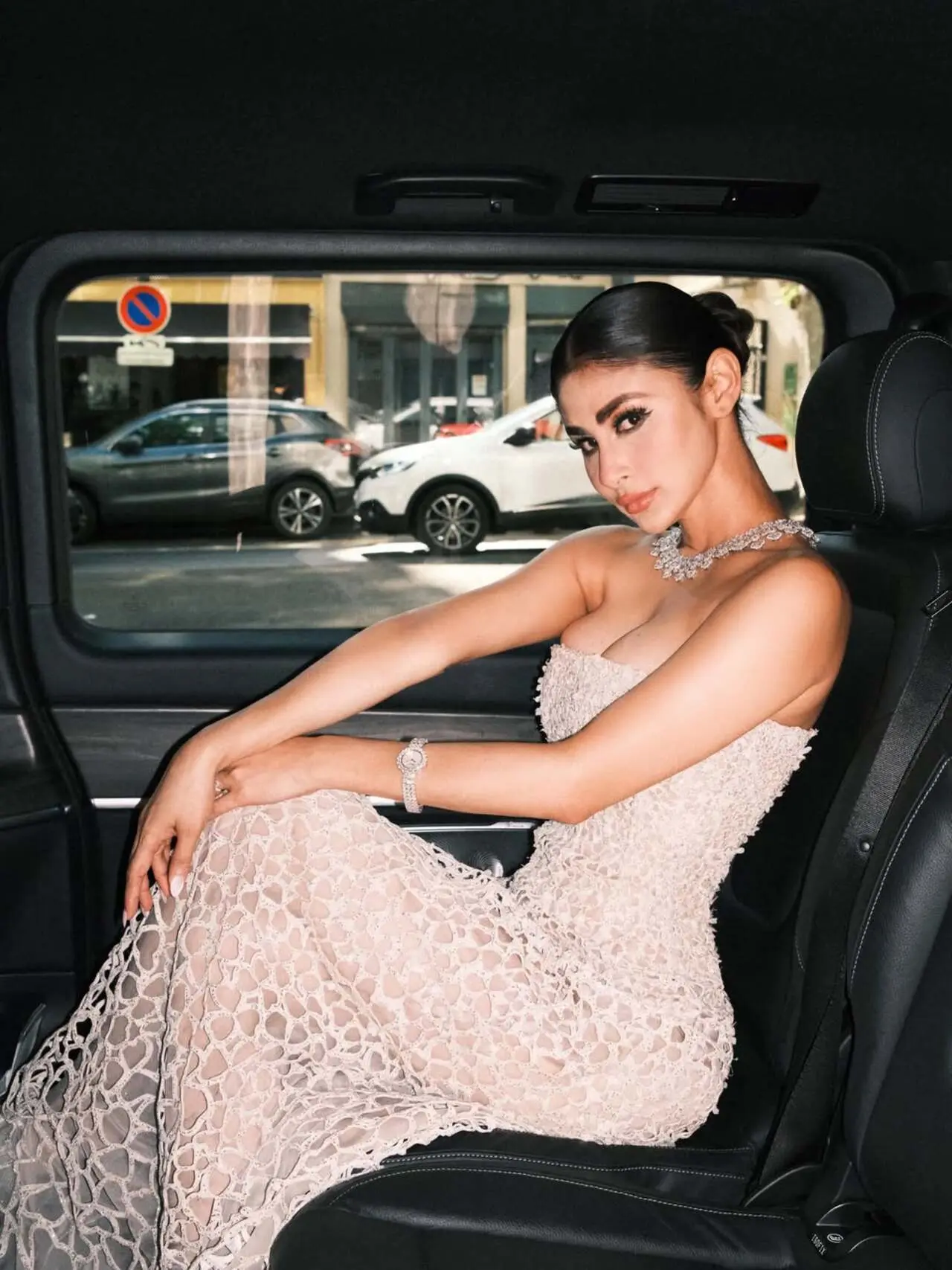 At the 2026 Cannes Film Festival, Mouni Roy channelled Old Hollywood luxury in a sheer ivory web-inspired gown by Caroline's Couture. The strapless silhouette featured an intricate latticework pattern glistening with thousands of micro-crystals. Elevating the glamour, she wore a heavy, floral-patterned Chopard diamond choker alongside a matching Precious Lace diamond watch and statement rings. A sleek, middle-parted low bun, dramatic winged eyeliner, and a matte nude lip flawlessly completed her radiant look At the 2026 Cannes Film Festival, Mouni Roy channelled Old Hollywood luxury in a sheer ivory web-inspired gown by Caroline's Couture. The strapless silhouette featured an intricate latticework pattern glistening with thousands of micro-crystals. Elevating the glamour, she wore a heavy, floral-patterned Chopard diamond choker alongside a matching Precious Lace diamond watch and statement rings. A sleek, middle-parted low bun, dramatic winged eyeliner, and a matte nude lip flawlessly completed her radiant look