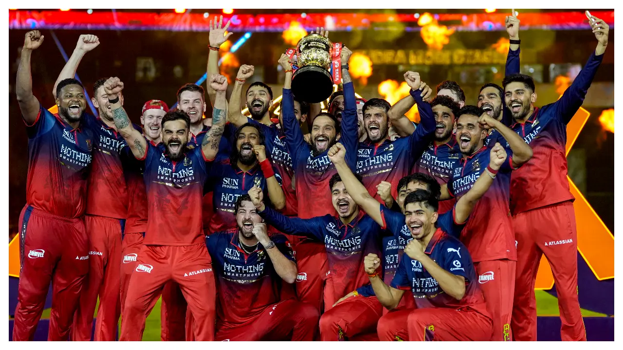 The RCB players posed with the trophy as they became just the third team in IPL history to win back-to-back titles. In the past, only Chennai Super Kings and Mumbai Indians have successfully defended their trophy. (Pic: PTI)