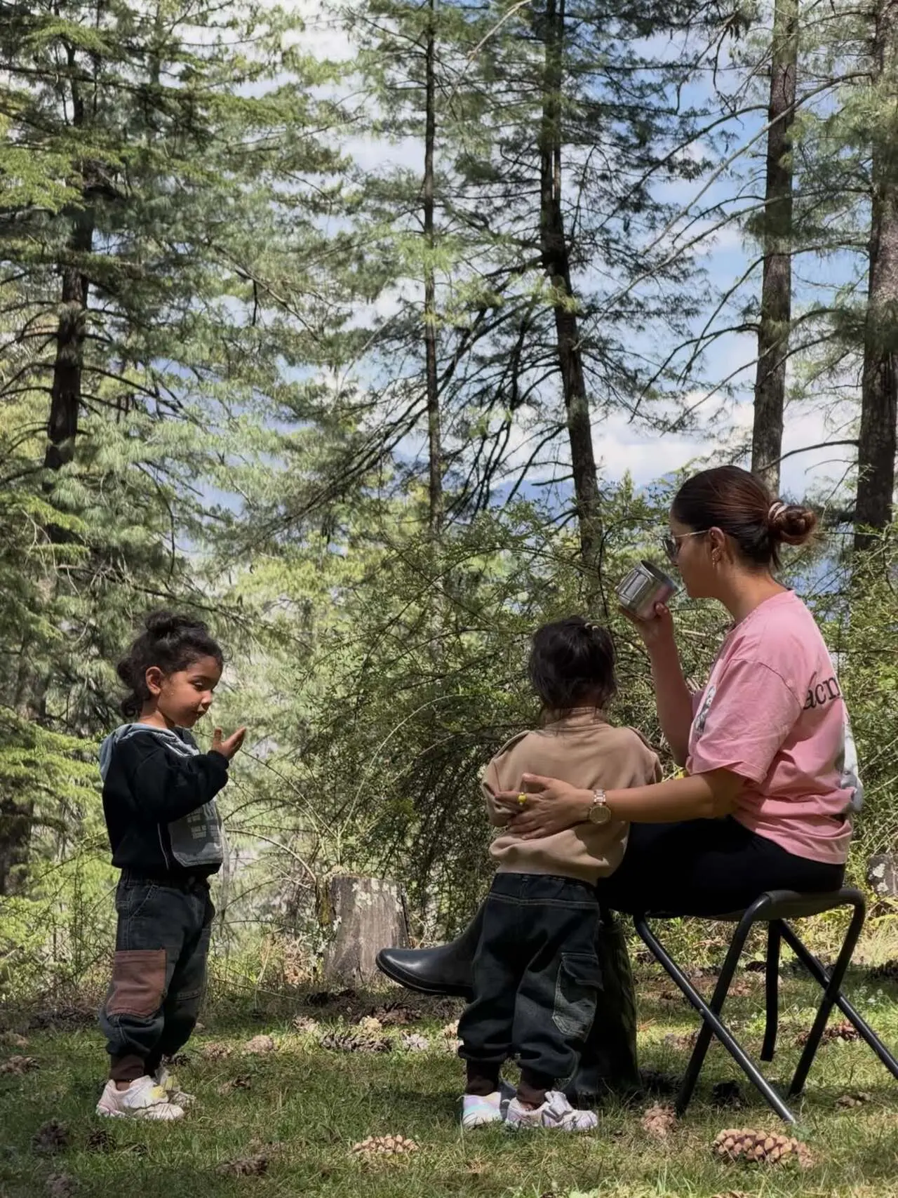 Rubina's little angels Jeeva and Edhaa&nbsp;enjoy snacks and playful moments beside a small camping table.