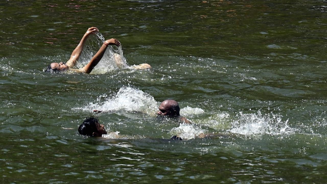 Some locals were seen enjoying at Banganga Tank in the afternoon scorching heat on Sunday afternoon Some locals were seen enjoying at Banganga Tank in the afternoon scorching heat on Sunday afternoon