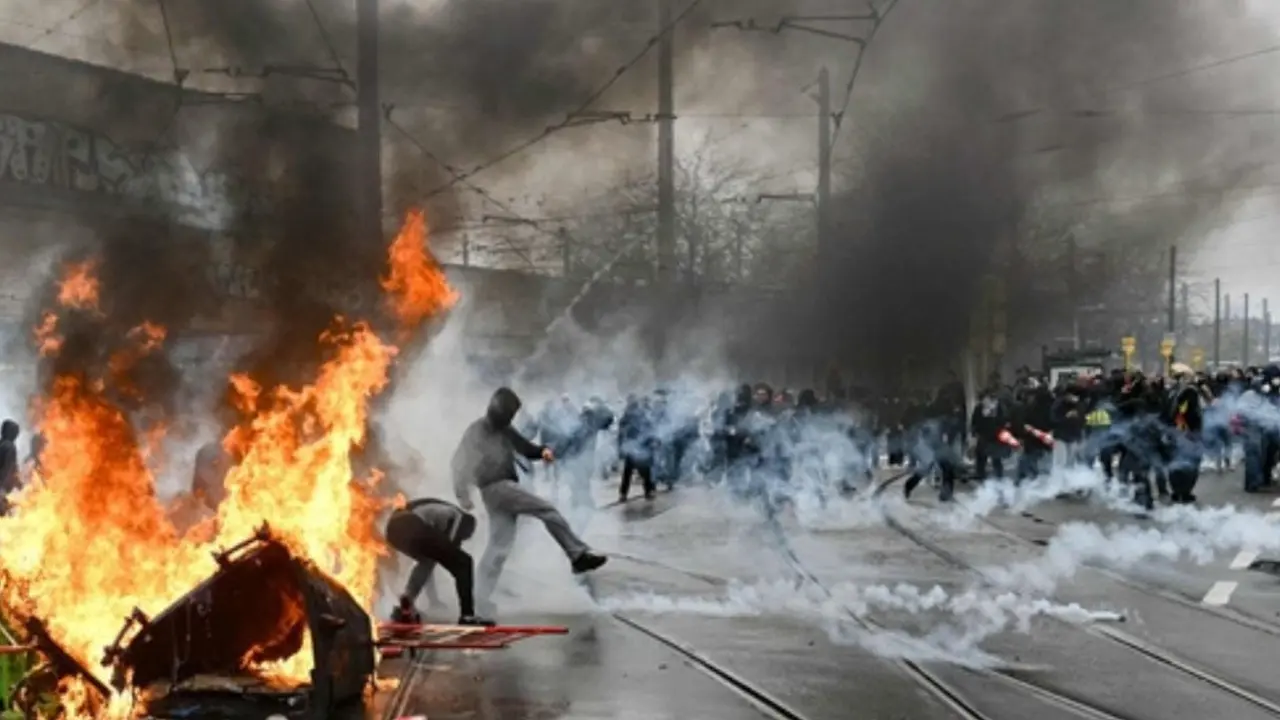 IN PHOTOS: Protest in Belgium's capital turns violent as youth clash with police A protester kicks back a tear gas canister during a labour union-based demonstration against the Federal Government's budgetary measures in Brussels on Friday. PIC/AFP