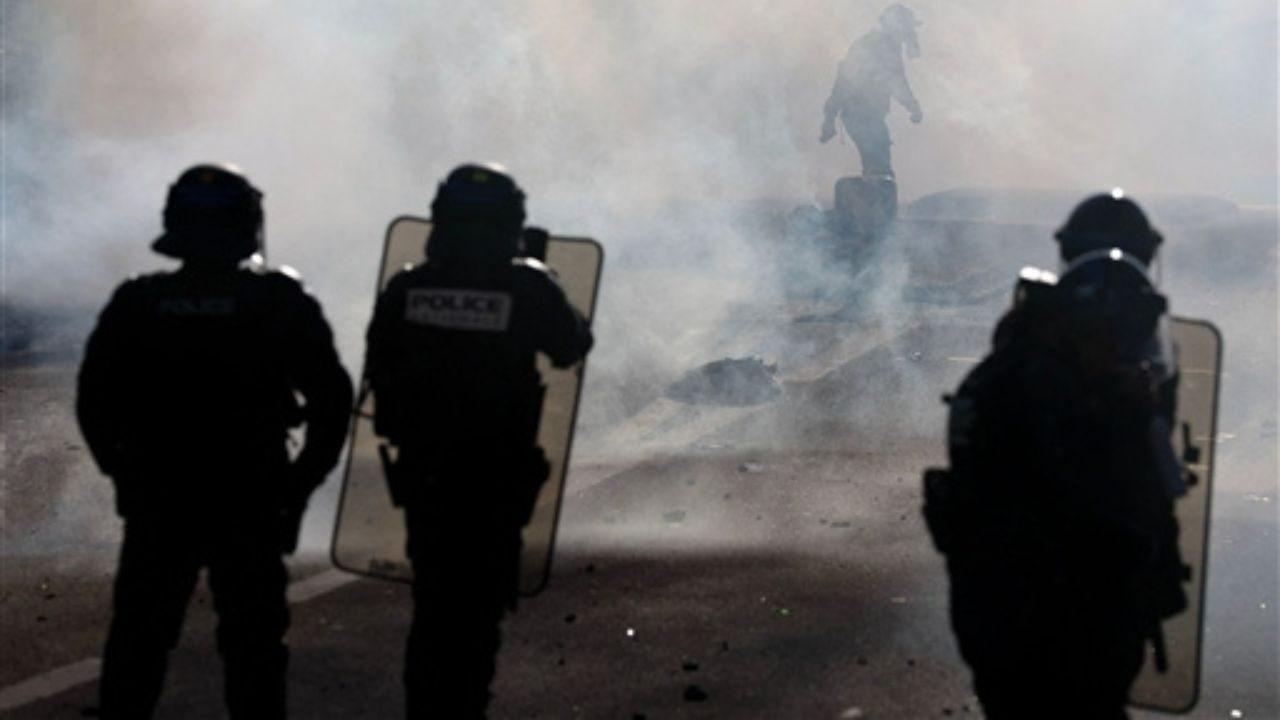 Tear gas fills the air as anti-riot police face off with protesting students carrying out blockading action at the Lycée Kerichen Secondary School, in Brest, western France.