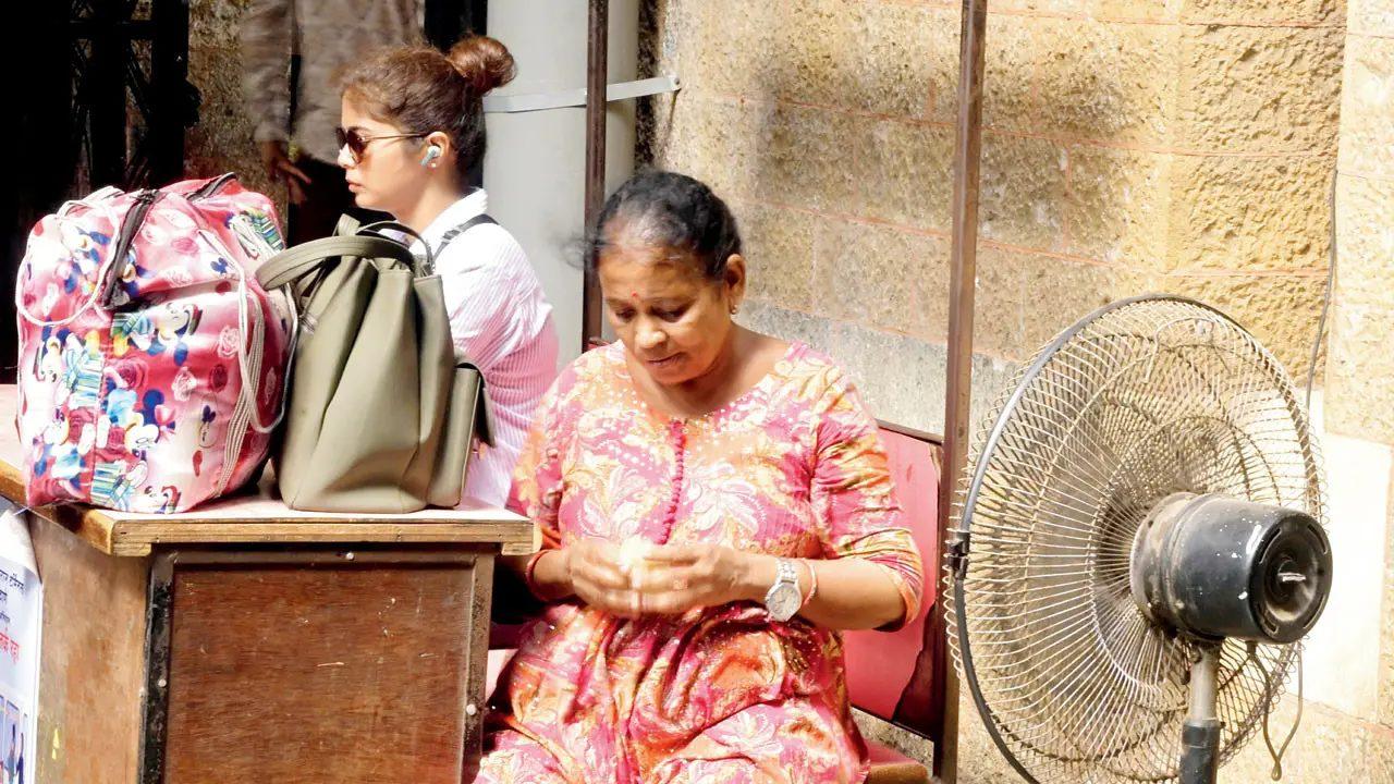 A fan provides relief to a woman at Chhatrapati Shivaji Maharaj Terminus- With the mercury rising to 37.8 degree Celsius at Santacruz, commuters and people at public spaces looked for ways to stay cool amid the heatwave A fan provides relief to a woman at Chhatrapati Shivaji Maharaj Terminus- With the mercury rising to 37.8 degree Celsius at Santacruz, commuters and people at public spaces looked for ways to stay cool amid the heatwave