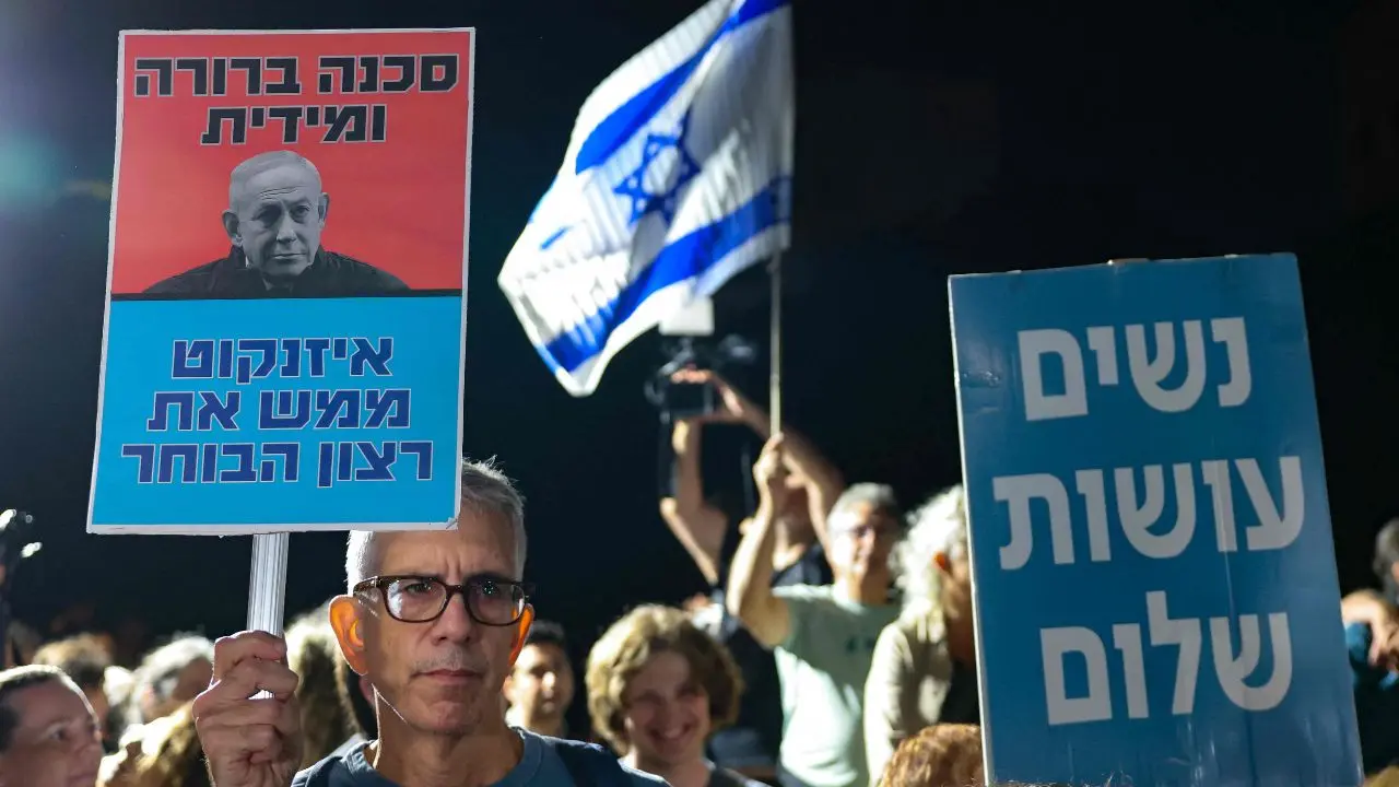 Israel election results: Netanyahu's bloc wins 53 seats, falls short of majority Israeli left-wing activists hold placards during a demonstration outside the home of Gadi Eisenkot (Pic/AFP)