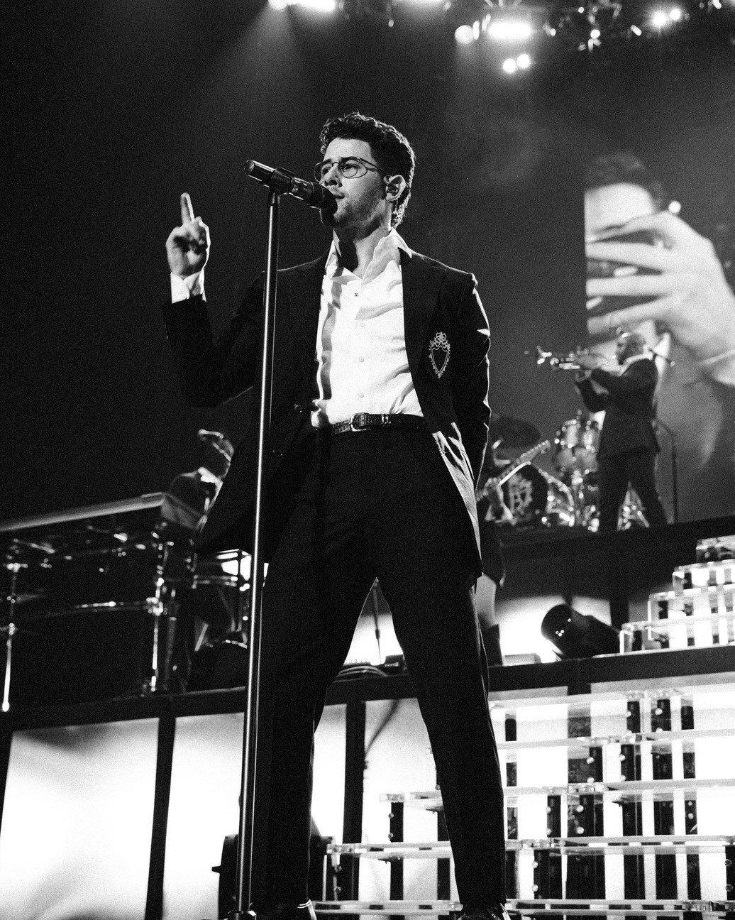 The carousel also includes many glimpses of Nick performing in front of a packed audience, including a striking black-and-white picture of the singer facing a sea of fans during his performance. The carousel also includes many glimpses of Nick performing in front of a packed audience, including a striking black-and-white picture of the singer facing a sea of fans during his performance.