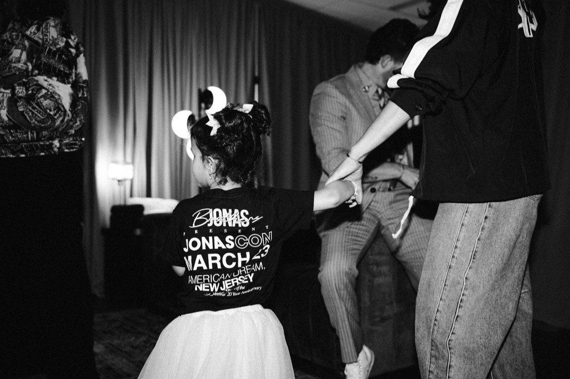 Another black-and-white picture captures Malti backstage with her parents, while Nick is seen in the background. Another black-and-white picture captures Malti backstage with her parents, while Nick is seen in the background.