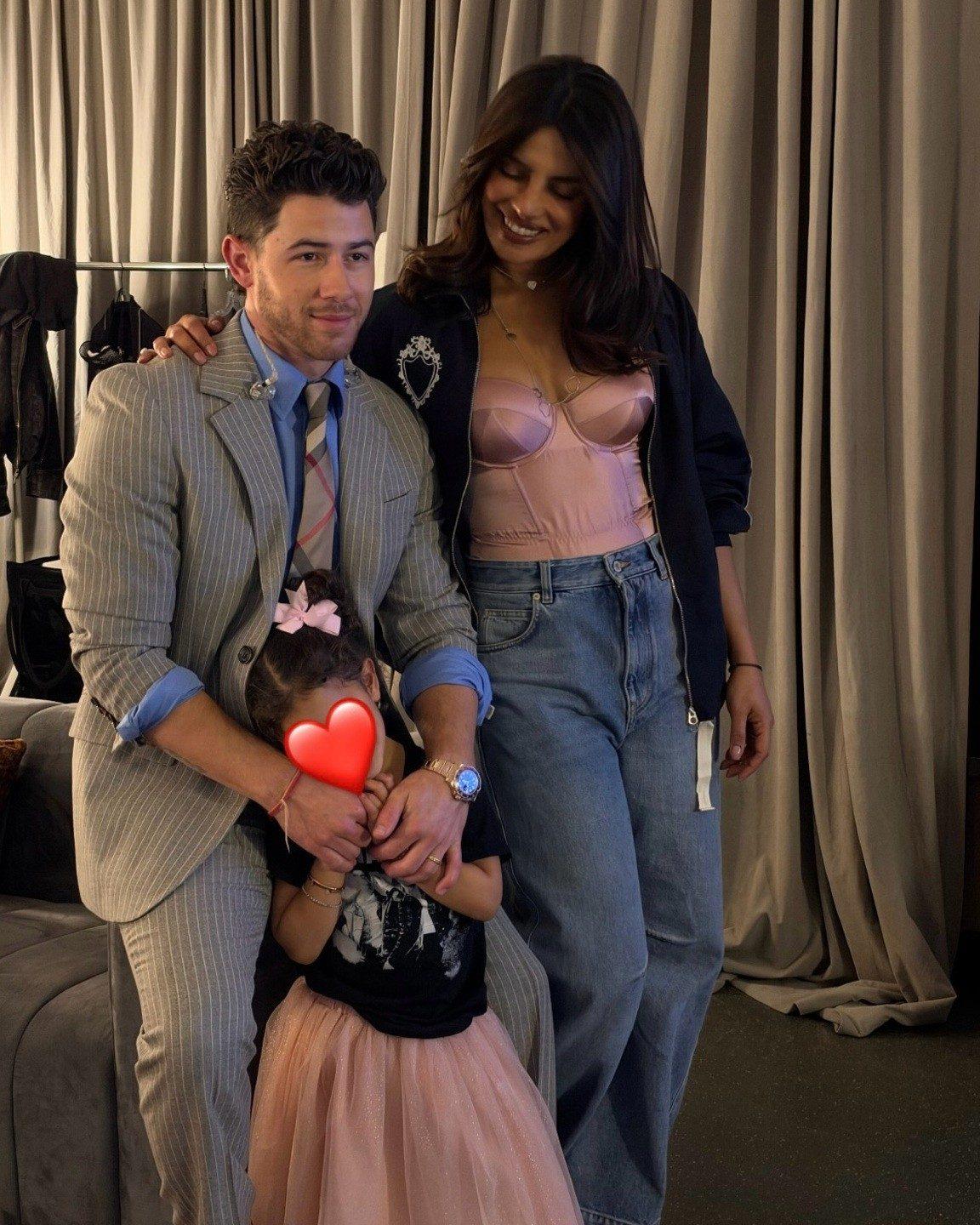 In another picture, Priyanka stands beside Nick as the couple pose with Malti, whose face has been covered with a heart emoji to protect her privacy. In another picture, Priyanka stands beside Nick as the couple pose with Malti, whose face has been covered with a heart emoji to protect her privacy.