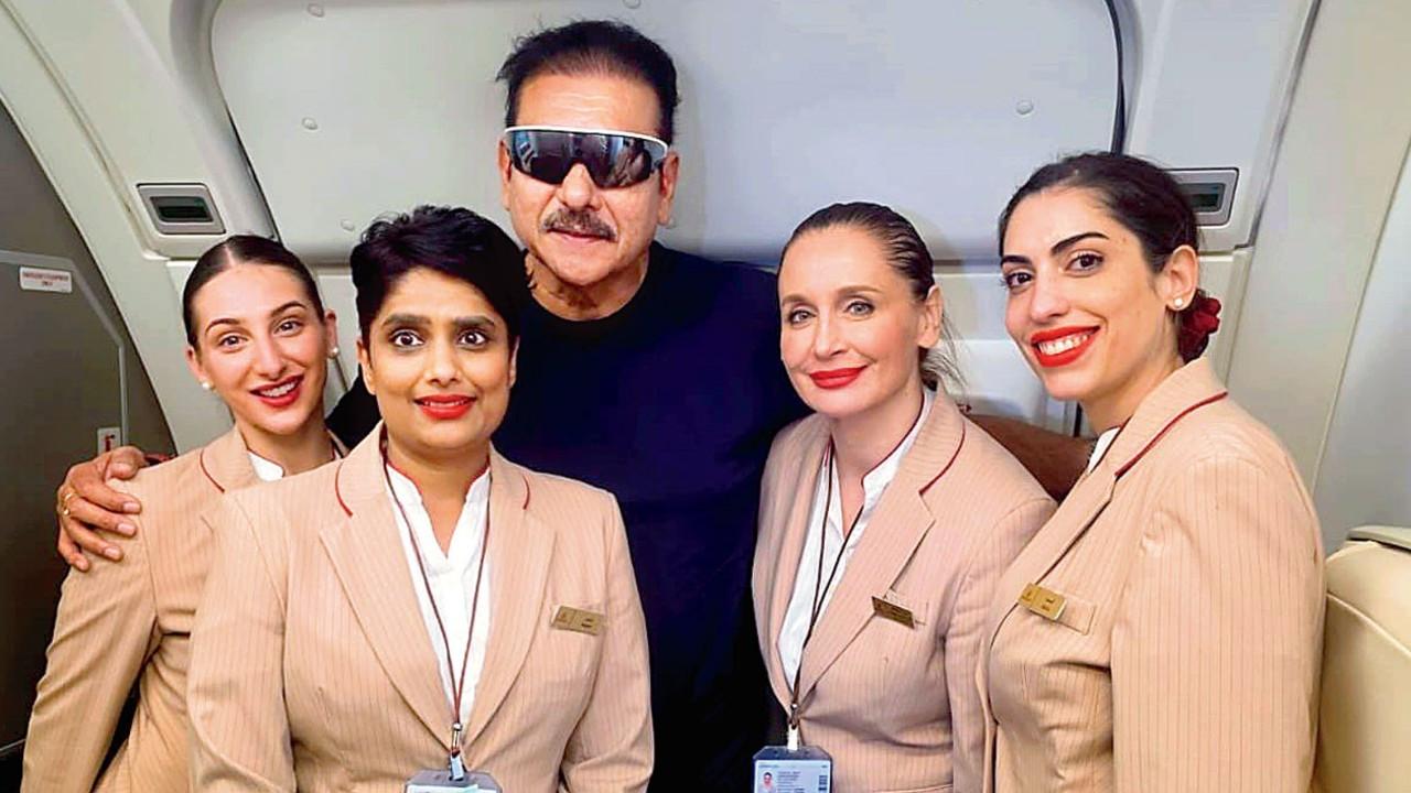 Ravi Shastri with the flight attendants. Pic/Shastri’s Instagram