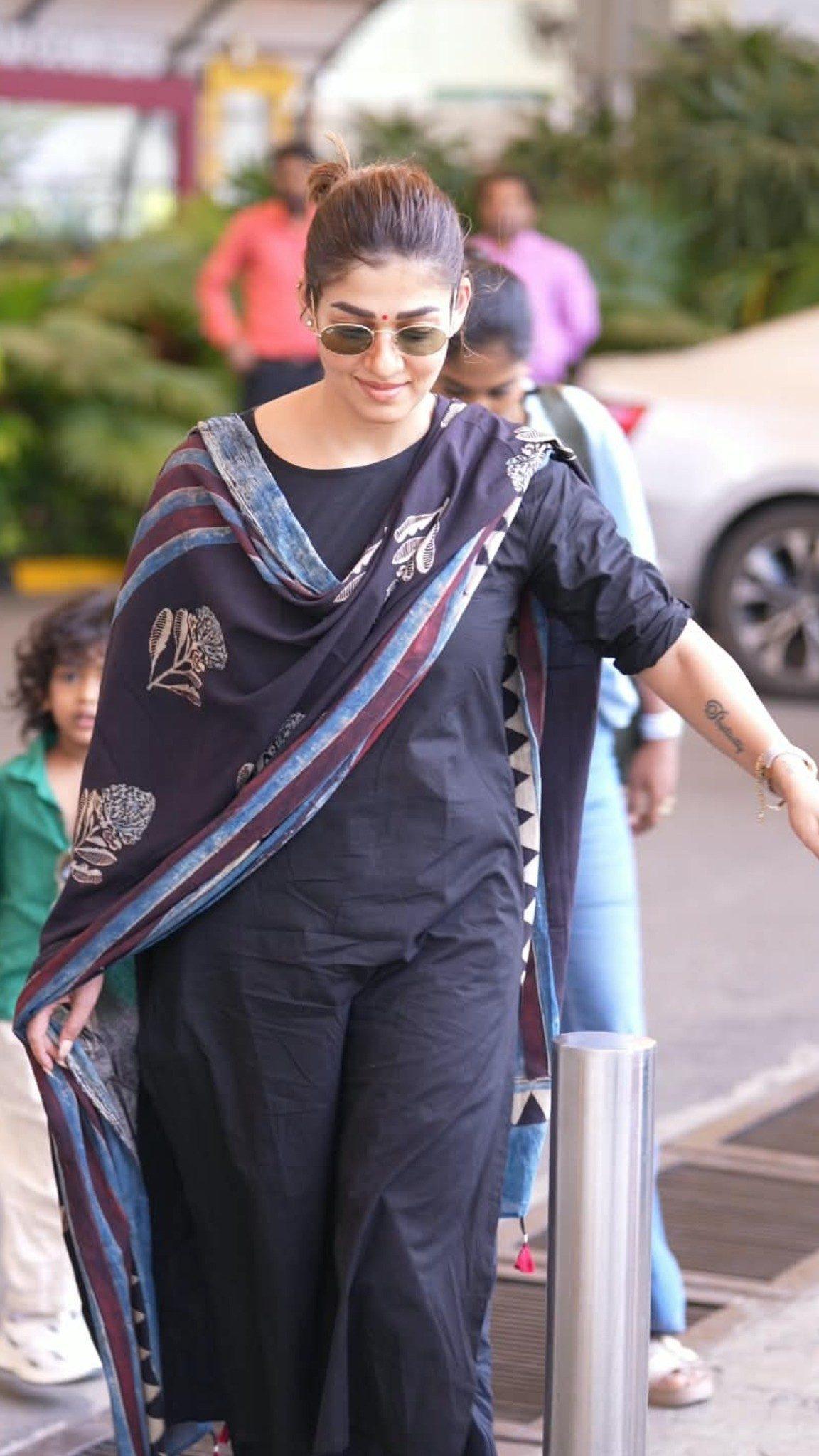 Nayanthara was recently spotted at the airport keeping it effortlessly chic in a stylish black ethnic suit paired with a printed dupatta. Nayanthara was recently spotted at the airport keeping it effortlessly chic in a stylish black ethnic suit paired with a printed dupatta.