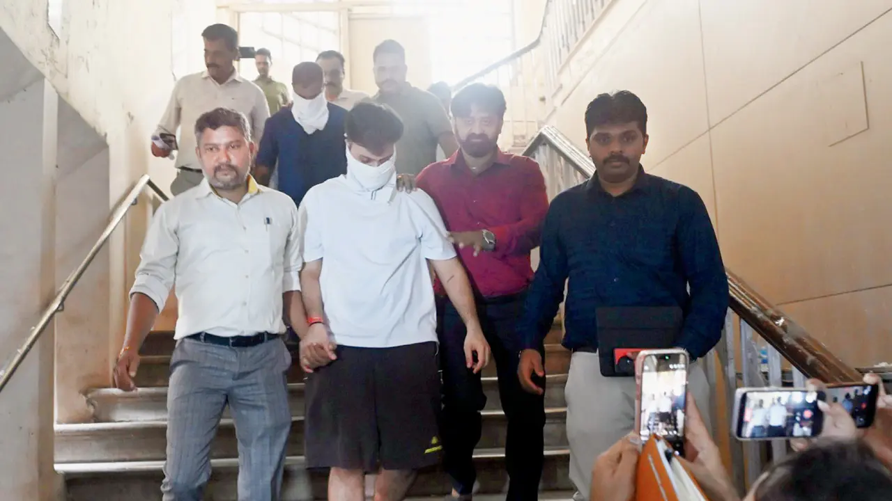 Accused Rohan Parekh (in white: face covered) and second accused Dilip Kunde (behind Parekh: face covered) were produced before the court on Tuesday following their arrest. PIC/ASHISH RAJE