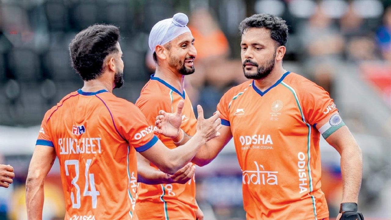 ‘Every team will look to contain Harmanpreet’ PR Sreejesh India skipper Harmanpreet Singh (right) celebrates scoring against Wales in the FIH World Cup last month. Pic/Hockey India