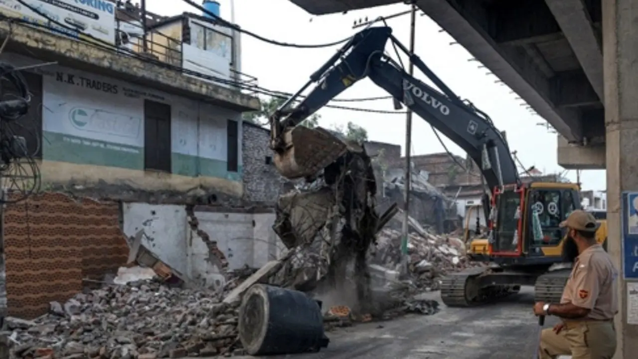 In Photos: Demolition drive in Jammu's Satwari area for highway expansion police official stands guard as a demolition drive being carried out by district administration at Nai Basti area, in Jammu, Jammu and Kashmir. Pic/PTI
