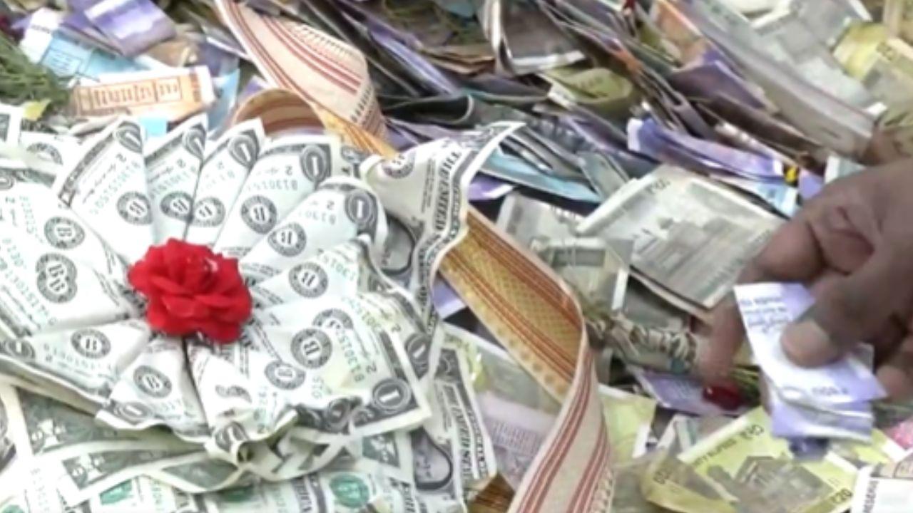 Devotees offer US dollar garland, gold and silver ornaments to Lalbaugcha Raja Dollar garland along with cash, gold and silver inside Lalbaugcha Raja's donation boxes (Pic/X@IANS)