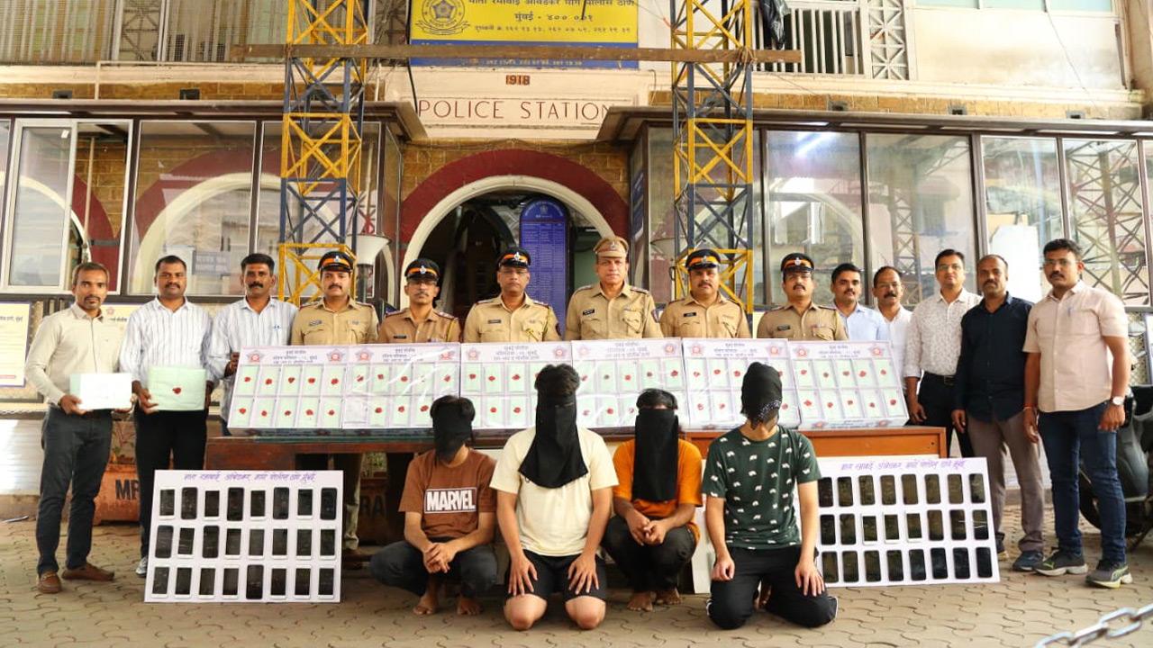 MRA Marg police with arrested accused (in hoods) and seized products
