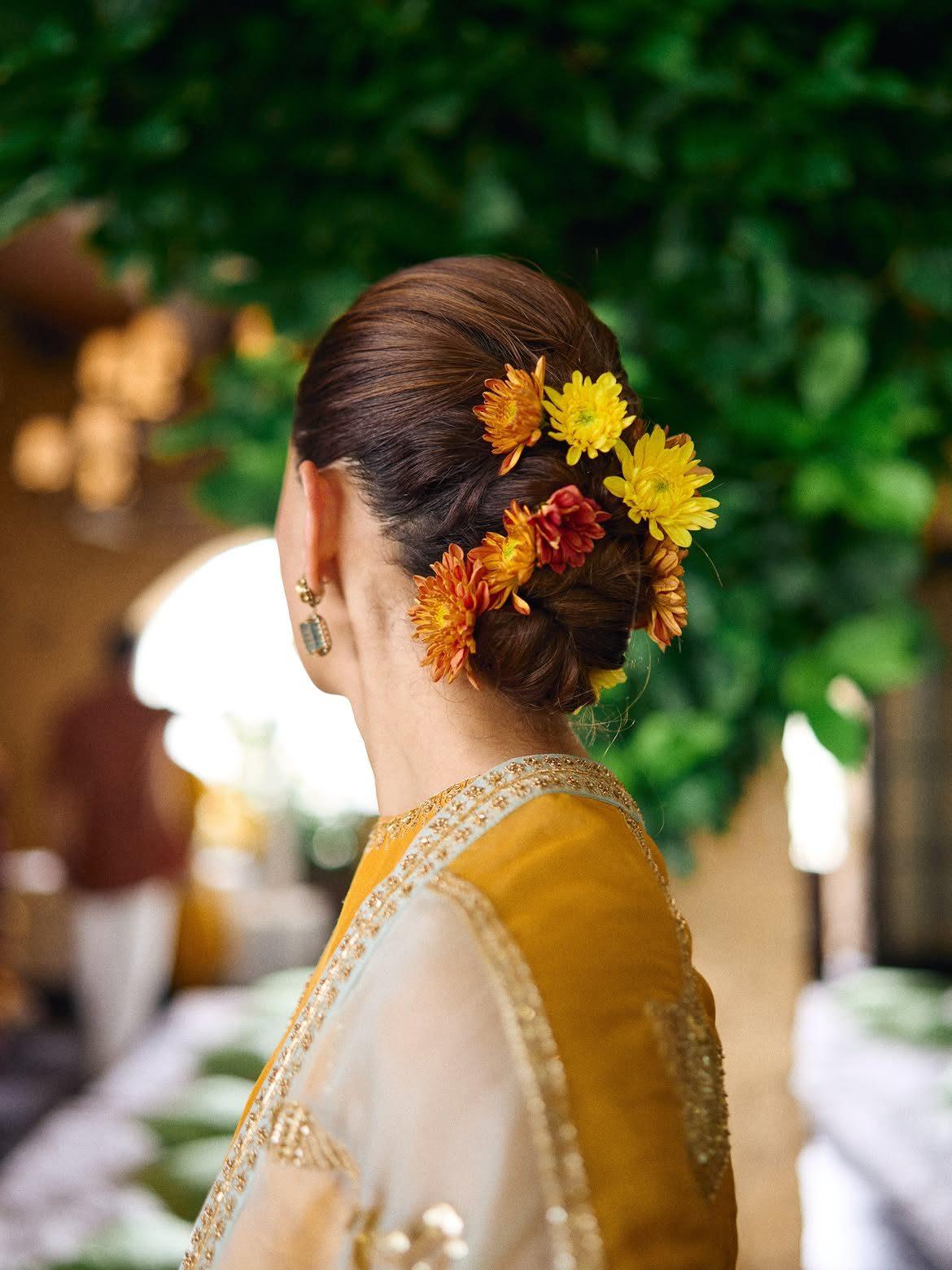 Alia Bhatt also shared a glimpse of her festive hairdo, a bun beautifully styled with yellow and orange flowers. Alia Bhatt also shared a glimpse of her festive hairdo, a bun beautifully styled with yellow and orange flowers.