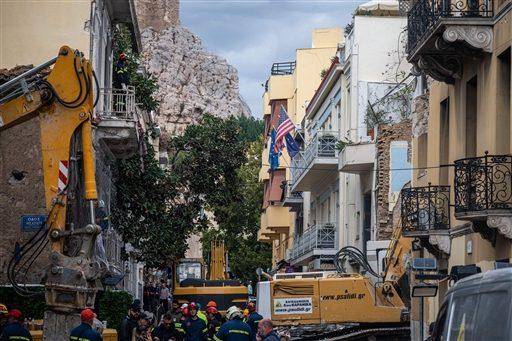 Emergency personnel work after an old building partially collapsed following an explosion in the Plaka area of central Athens.
