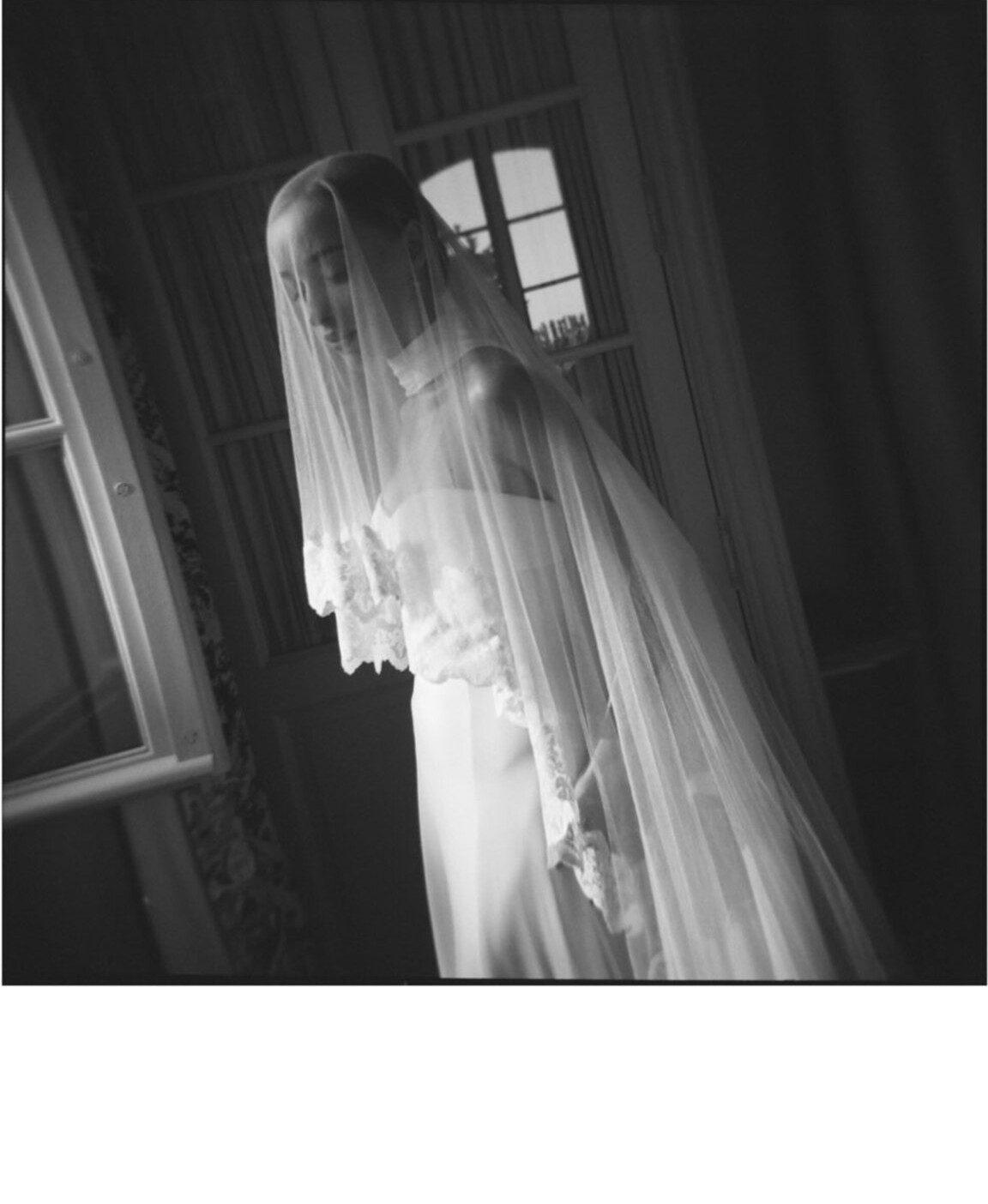 She completed her bridal look with a trailing neck scarf and a cathedral-length silk veil.
