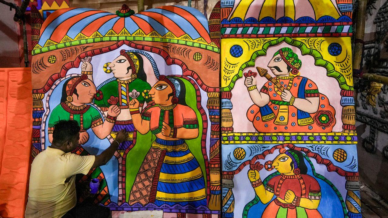 An artist works on an artwork depicting Rajasthani festival ‘Gangaur’ at a community 'pandal' as preparations are underway ahead of Durga Puja festival, in Kolkata, West Bengal, Tuesday, September 22