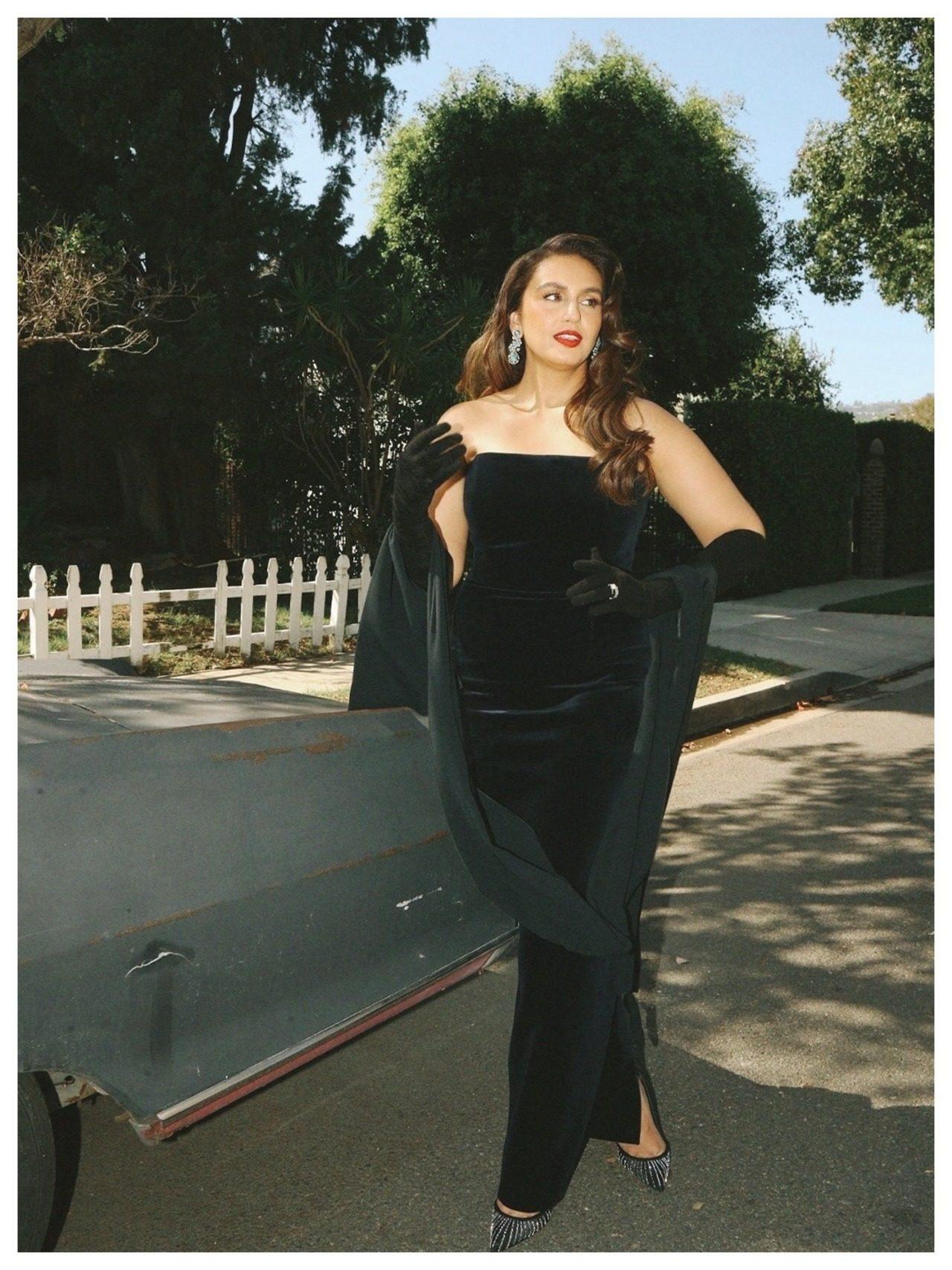 She paired it with a matching draped shawl trailing behind her, and opera-length black gloves. She paired it with a matching draped shawl trailing behind her, and opera-length black gloves.