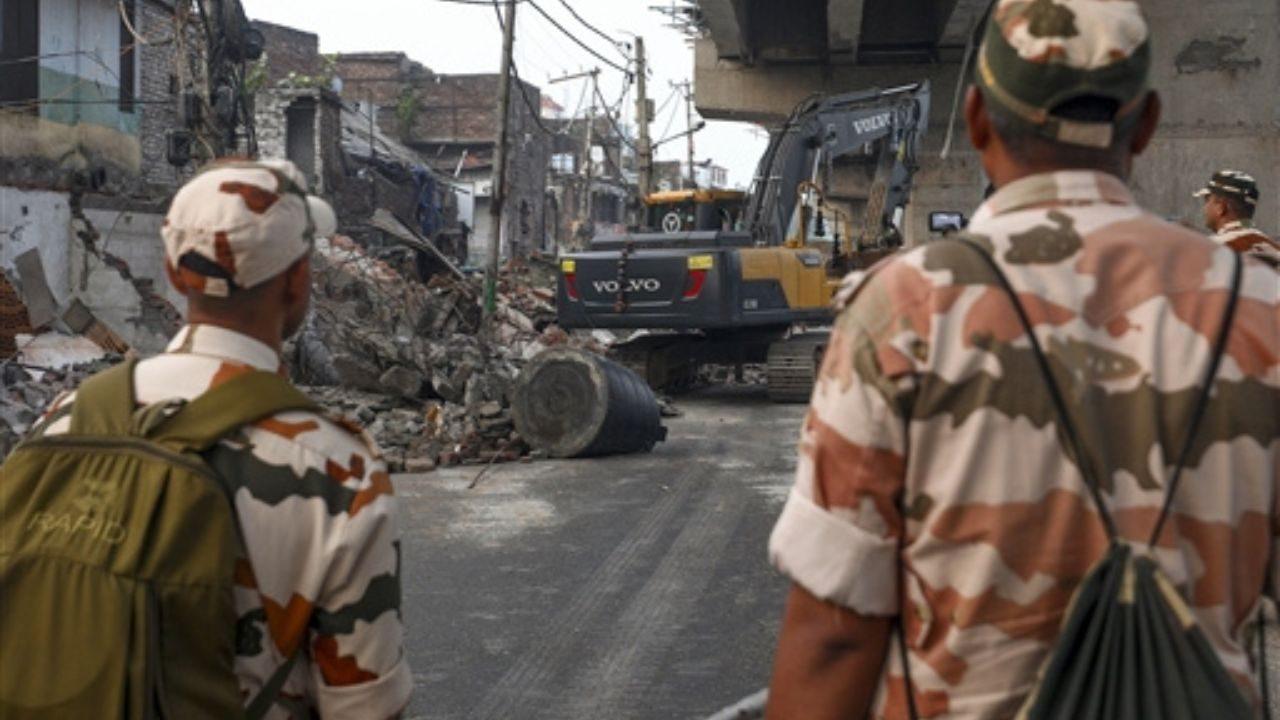 Security personnel at the site as a demolition drive being carried out by district administration at Nai basti area, in Jammu, Jammu and Kashmir Security personnel at the site as a demolition drive being carried out by district administration at Nai basti area, in Jammu, Jammu and Kashmir