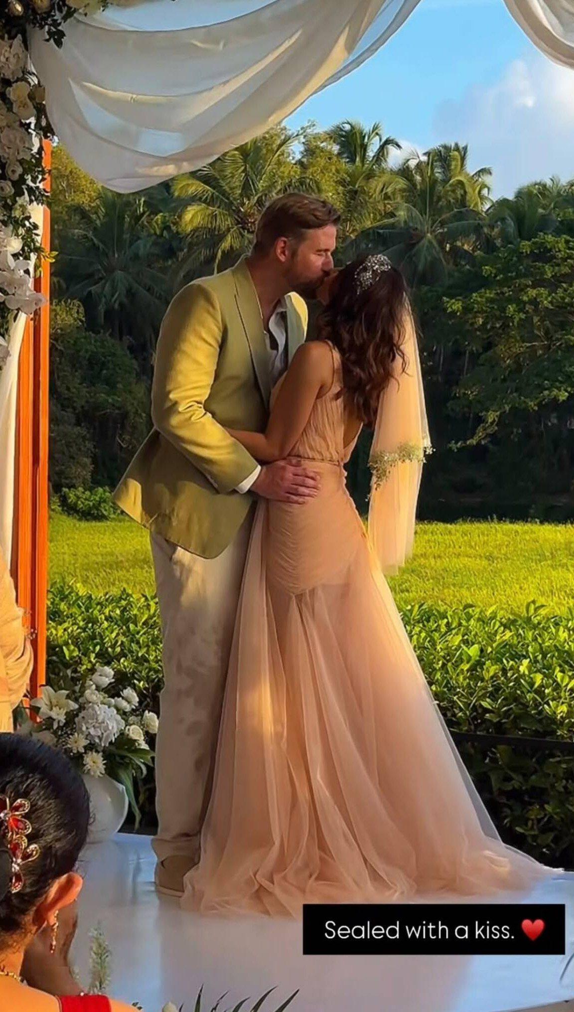 William perfectly complements her serene aesthetic in a sharp beige-and-tan tailored suit. The couple were seen sealing the deal with a passionate kiss.