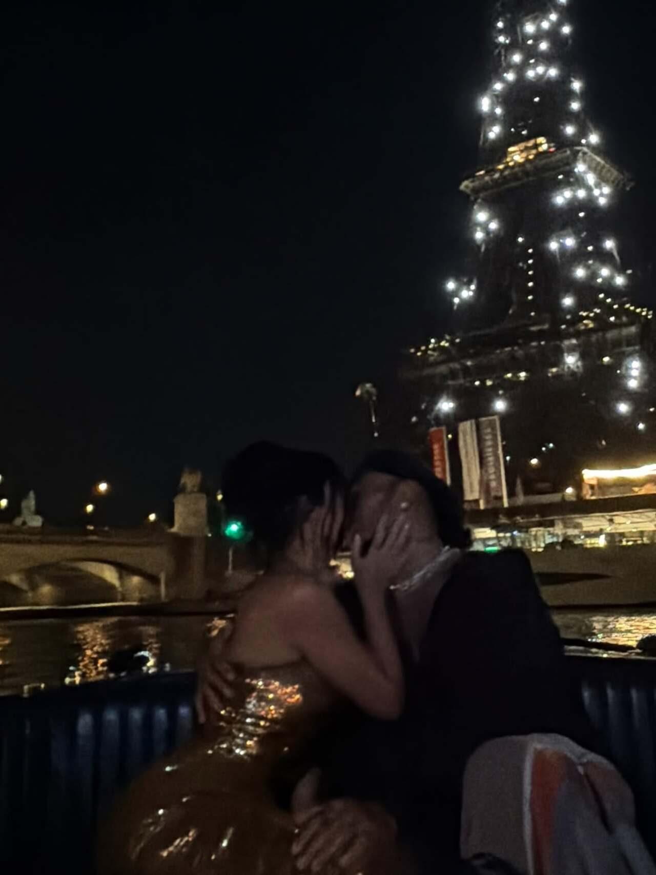 Kim and Lewis steal the kiss right under that majestic Eiffel Tower view