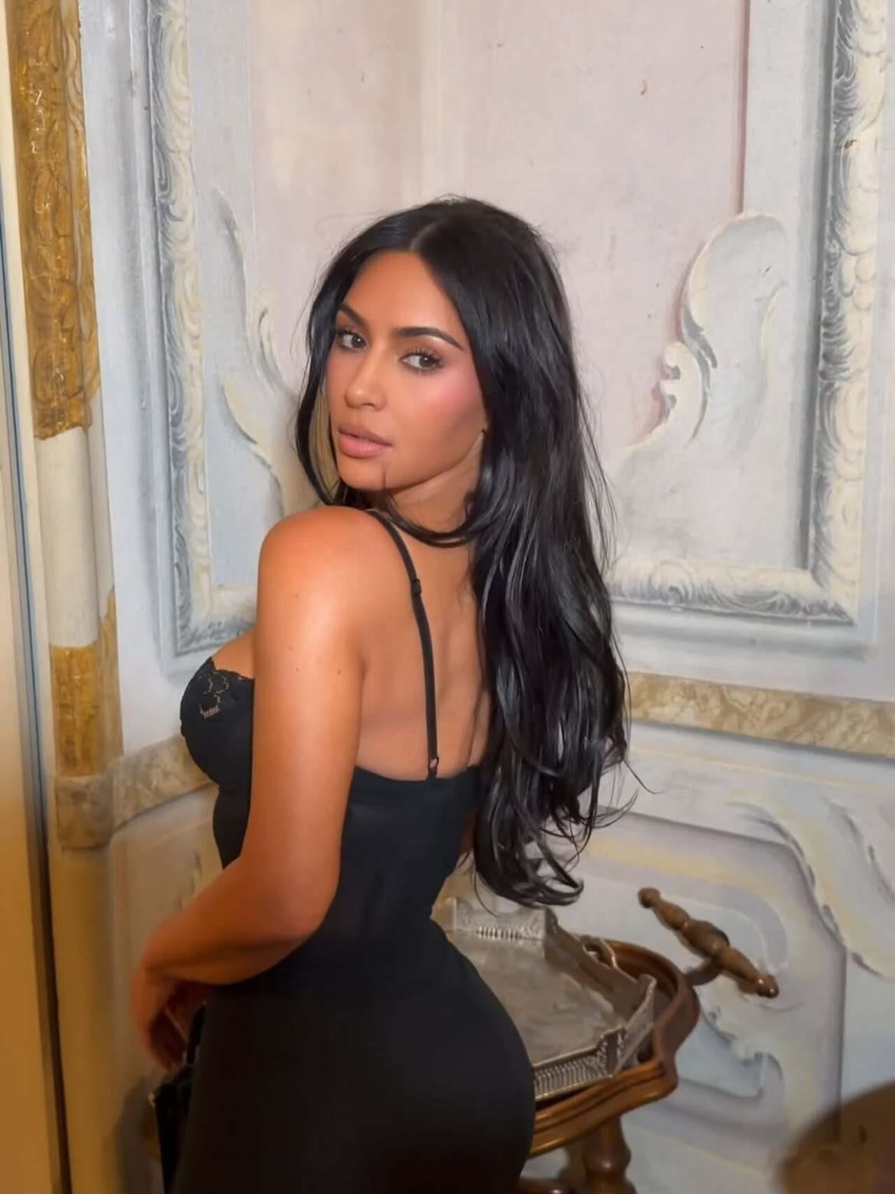 All you need to do to turn up the heat with your outfit. Kim keeps the hair and makeup minimal for the look and lets the dress take over