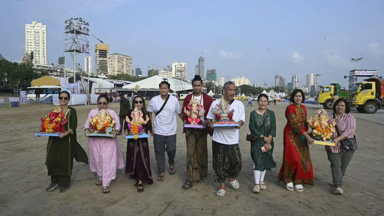 Thai devotees carry Ganesh idols for immersion. Devotees from Thailand visit Mumbai every year to celebrate the Ganesh festival and participate in the traditional immersion ceremony