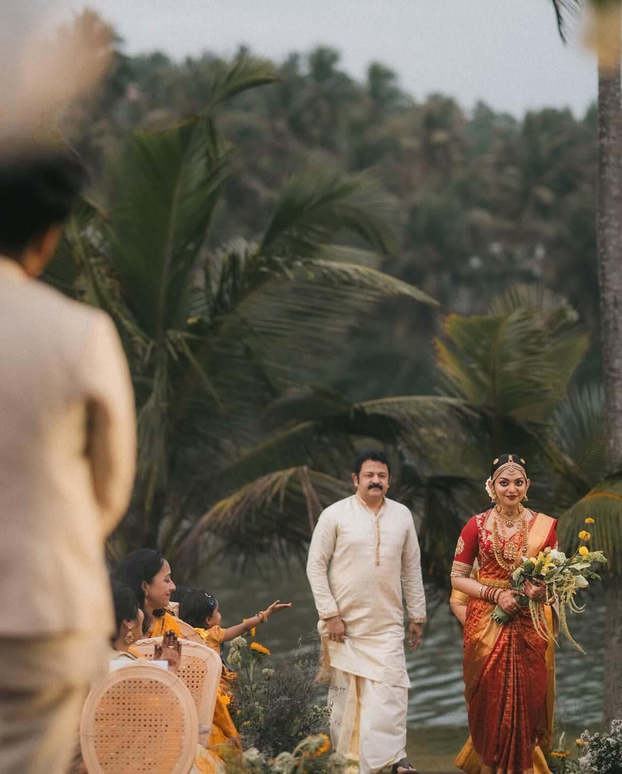 That emotional moment, when Ahaana's father walks her down the aisle with a bouquet of white and yellow flowers in her hand. The guests are awestruck looking at the gorgeous bride