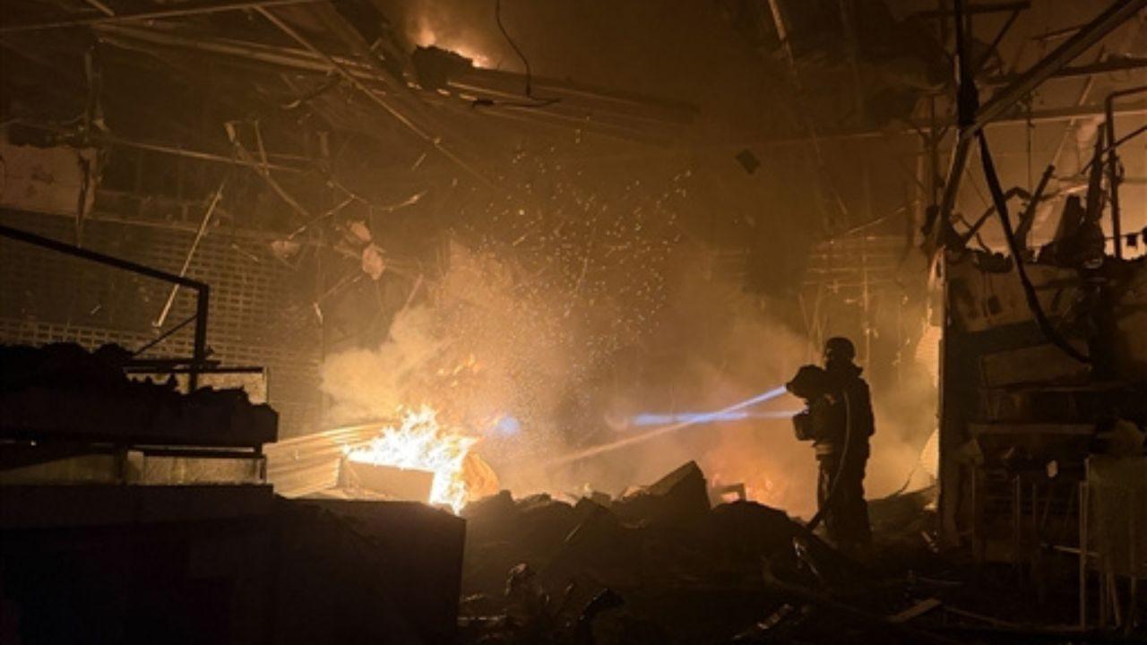 Firefighters and rescuers respond to a blaze at a shopping mall in Zaporizhzhia after the building was damaged in a Russian air attack
