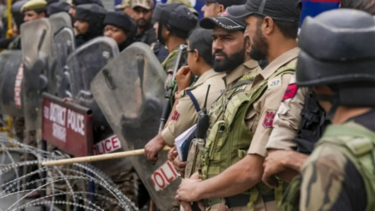 Police personnel keep a vigil during a protest called by Jammu and Kashmir casual and daily wages forum, in Srinagar Police personnel keep a vigil during a protest called by Jammu and Kashmir casual and daily wages forum, in Srinagar