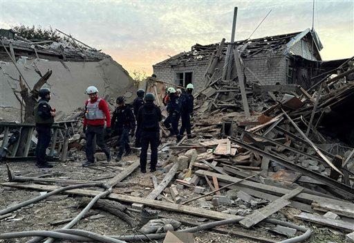 Rescuers search the debris of a damaged house after the air attack.