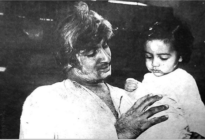 Abhishek Bachchan's dad Amitabh Bachchan is playing with his toddler here. Looks like a picture clicked during Holi!