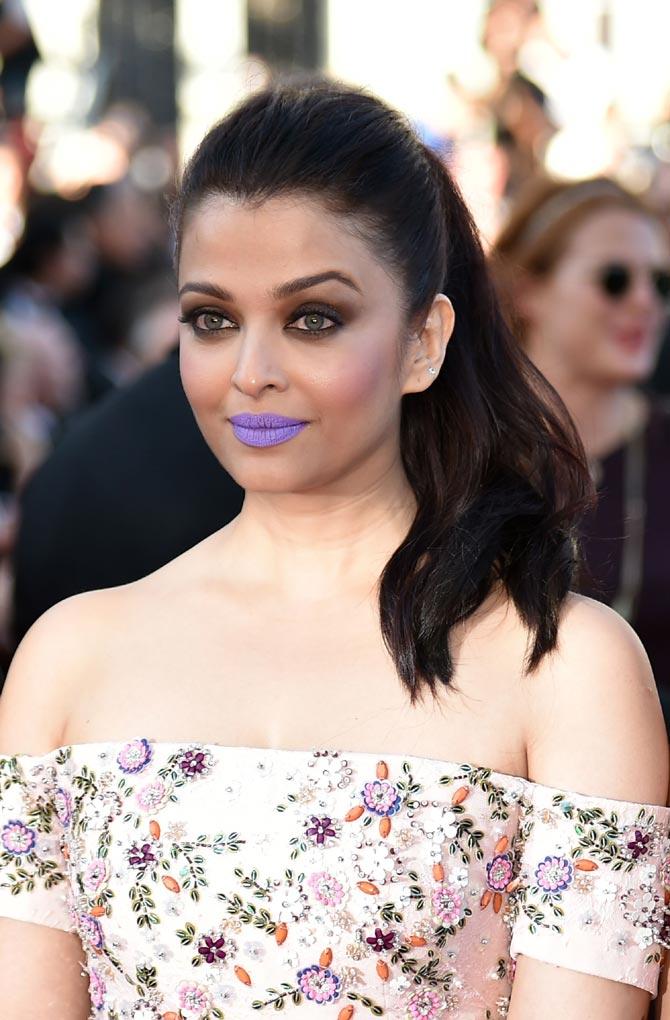 Aishwarya Rai Bachchan made a bold fashion statement with a pop lilac lip colour, paired with an embellished light pink dress at the 69th Cannes Film Festival in France. Pic/AFP