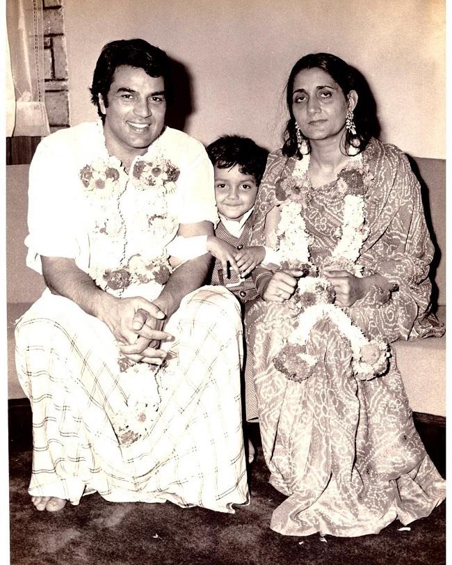 A young Bobby Deol can be seen seated in between his parents Dharmendra and Parkash Kaur - the picture was taken on their wedding anniversary.