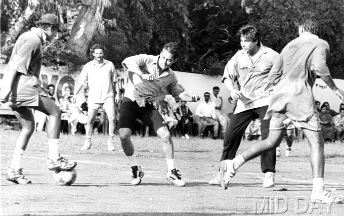 Salman Khan trying his hand at some soccer. Standing behind him is Milind Gunaji and right next to him is Deepak Tijori.