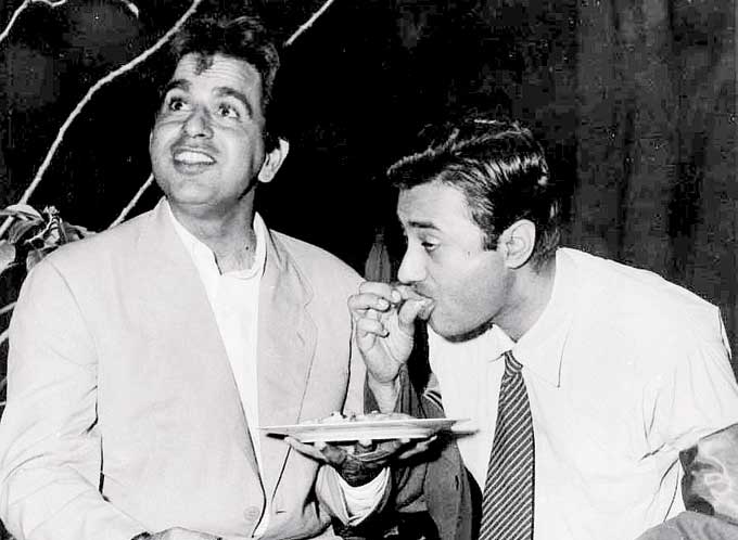 After completing his studies (the early 40s), Dev Anand moved to Bombay to began his career. He started off with a job in the military censor's office at Churchgate. Later, he worked as a clerk in an accounting firm too. In picture: Dev Anand grabs a bite from Dilip Kumar's plate on a film set