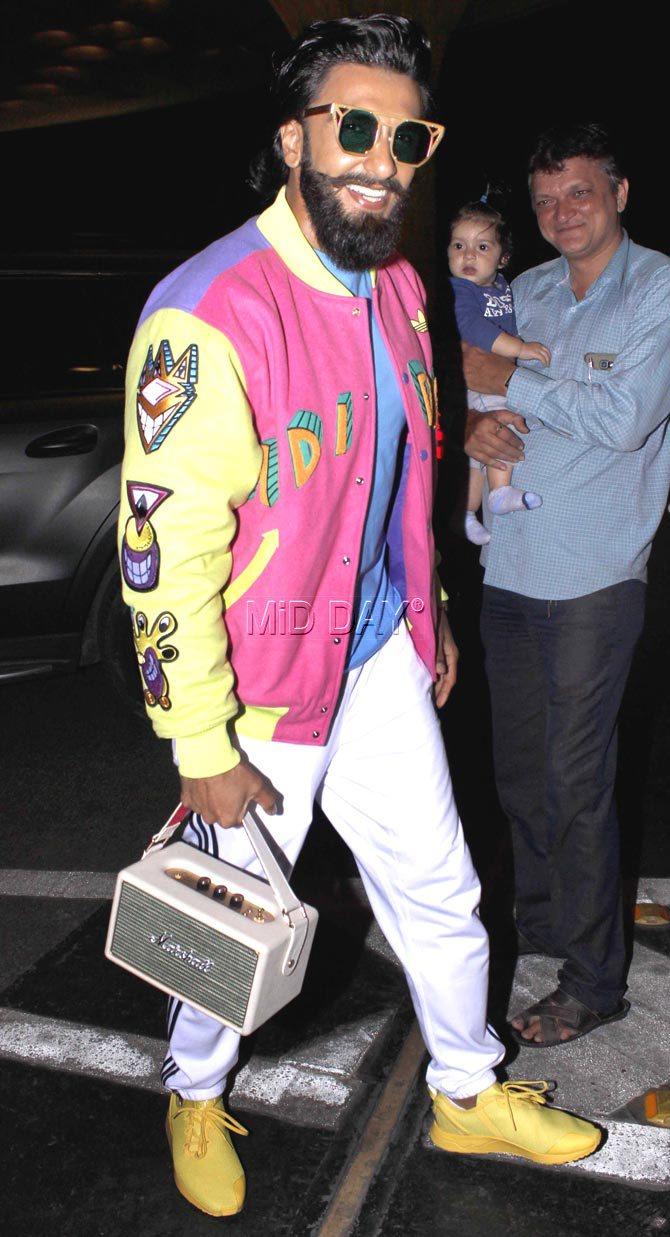 Ranveer Singh made heads turn at the airport as he was seen flaunting a pink and yellow bomber jacket with his own jukebox, that's something that only he could carry with his spunk and confidence