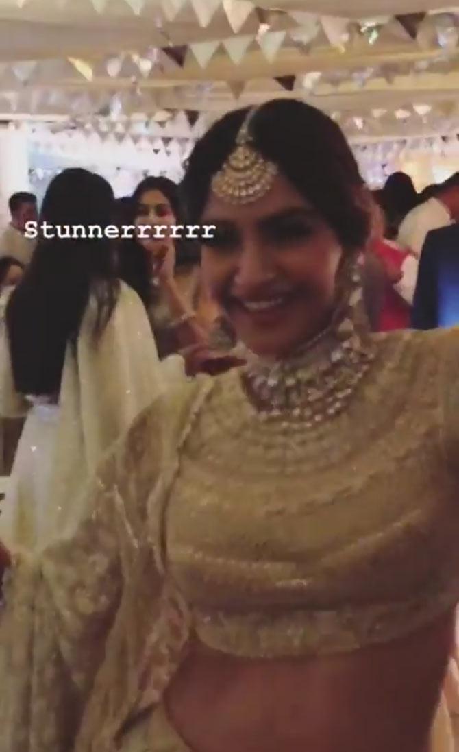 Sonam Kapoor matched the dress with traditional jewellery - jadau neckpiece, maang-tika and jhumkas. Her hair was neatly done up in a long braid and adorned with a white garland.