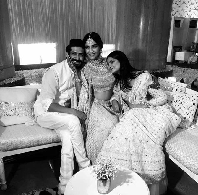 Siblings Harshvardhan Kapoor, Sonam Kapoor and Rhea Kapoor pose for the shutterbugs during the sangeet ceremony.