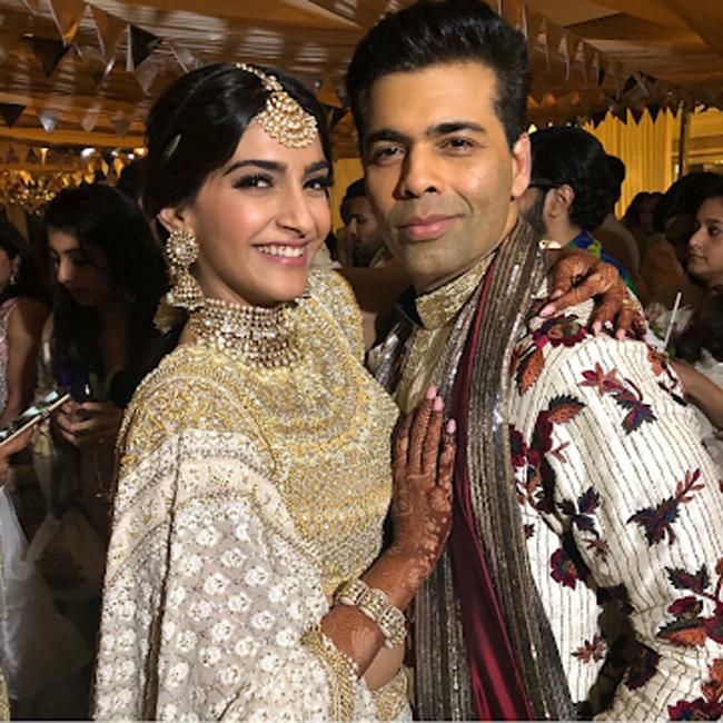 Karan Johar poses with the Sonam Kapoor during the sangeet ceremony.