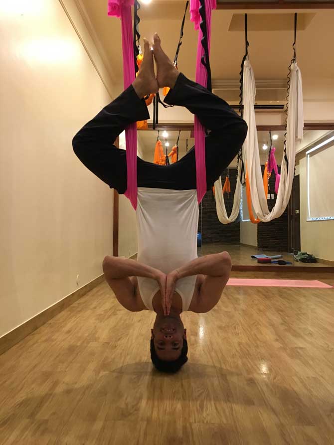 Tusshar Kapoor performs a Fly-Fit pose at Anshuka Yoga studio. His instructor Anshuka Parwani shared this image and captioned it, 'The #AirFit inverted #ButterflyPose #Baddhakonasana helps to open up that groin, inner thighs and hamstrings while working that core with all the benefits of an #inversion. #aerialyoga #painful #destressing #bandra #strengthening #balance #peace #bloodcirculation.